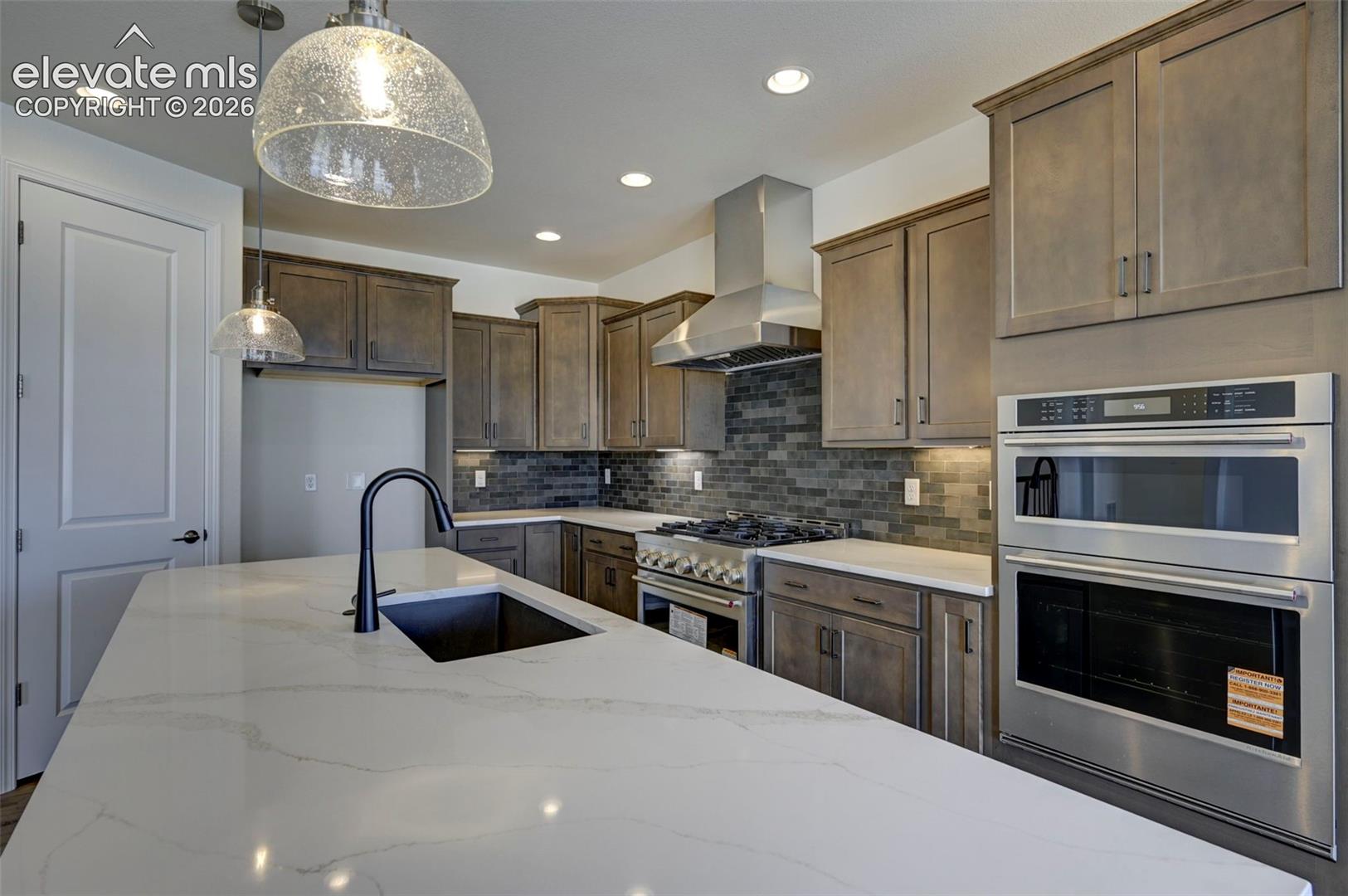 36" commercial gas range with external stainless vent hood, wall-in convection microwave oven and secondary oven