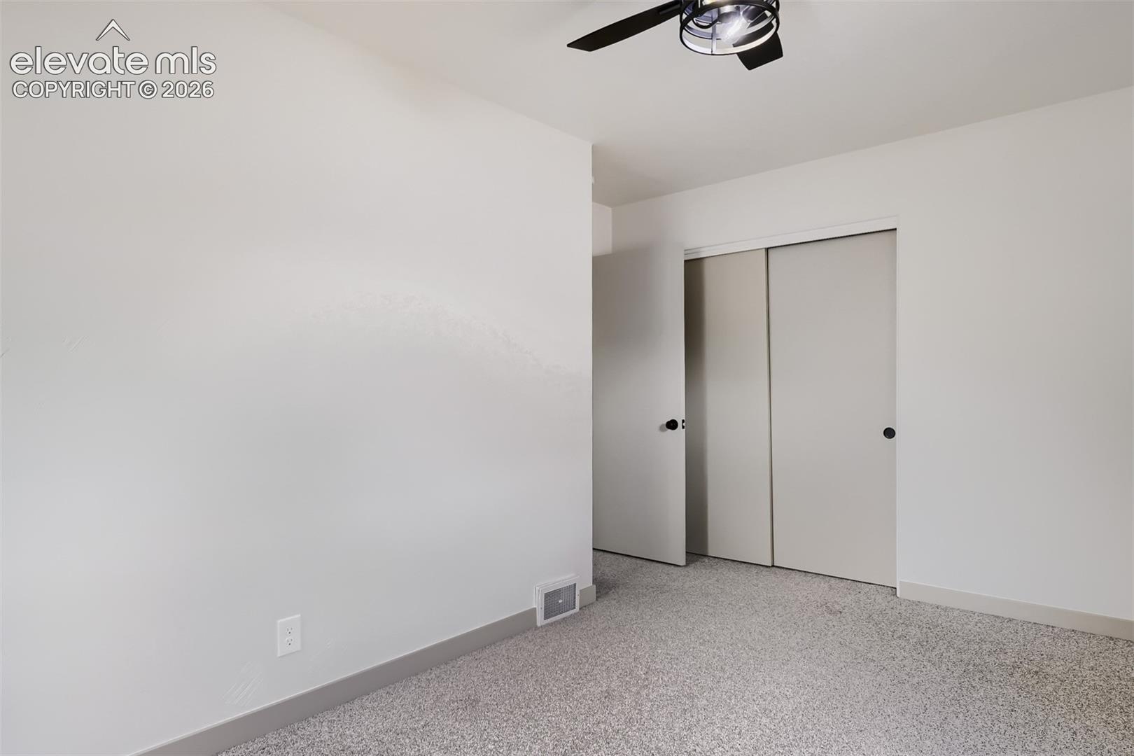 Recessed lighting with a ceiling fan, light-toned carpet, and neutral wall paint