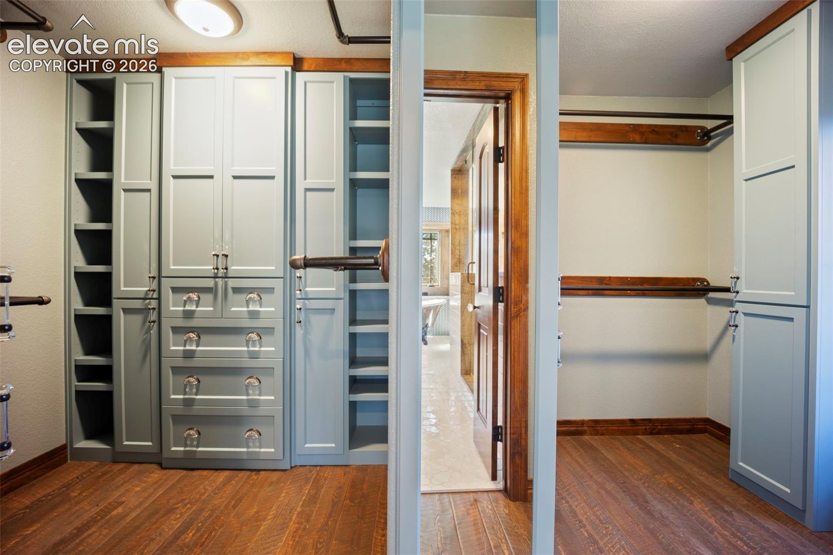 Custom closet system featuring built-in cabinetry, shelving, and drawers