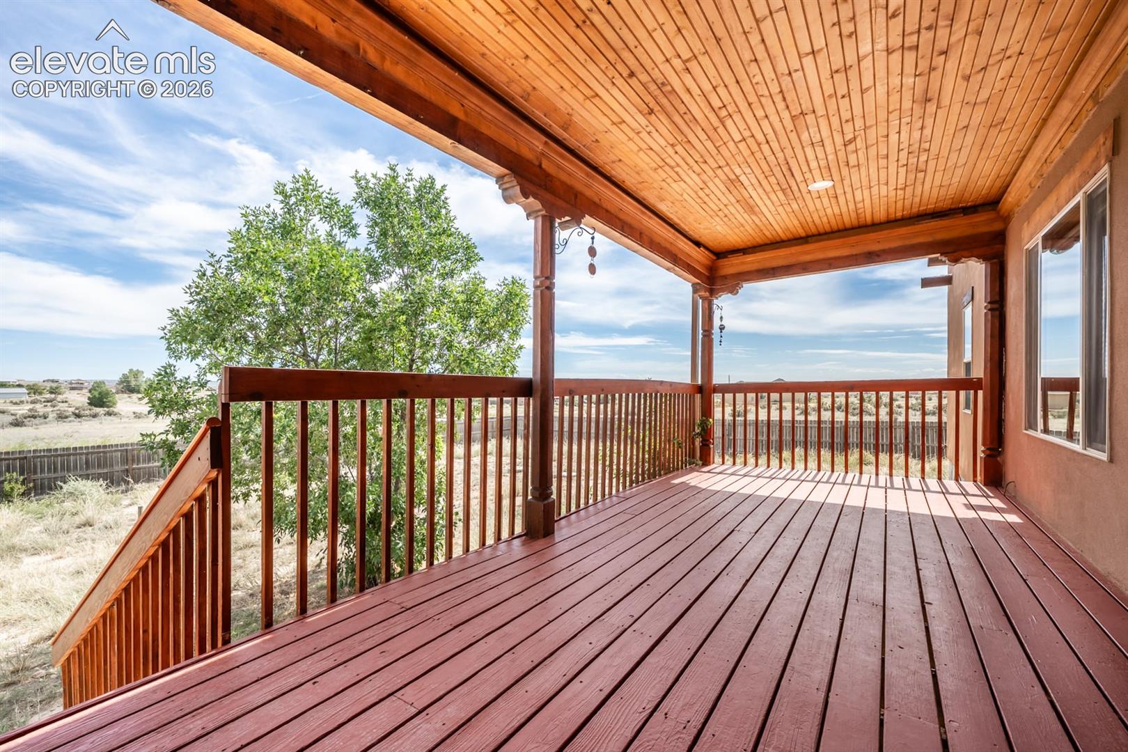 Beautifully covered back deck with fresh paint.  