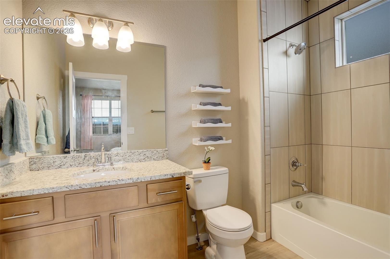Carpeted bedroom featuring baseboards and connected bathroom