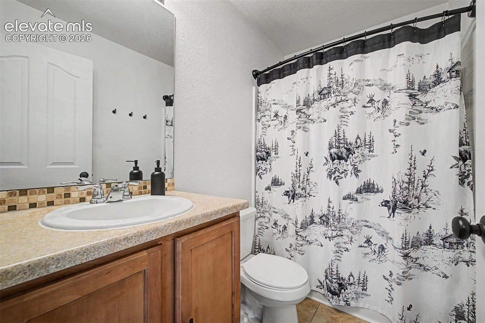 This full secondary bathroom is clean, functional, and carries the home's nature-inspired personality all the way through — a well-appointed space for family or guests alike.