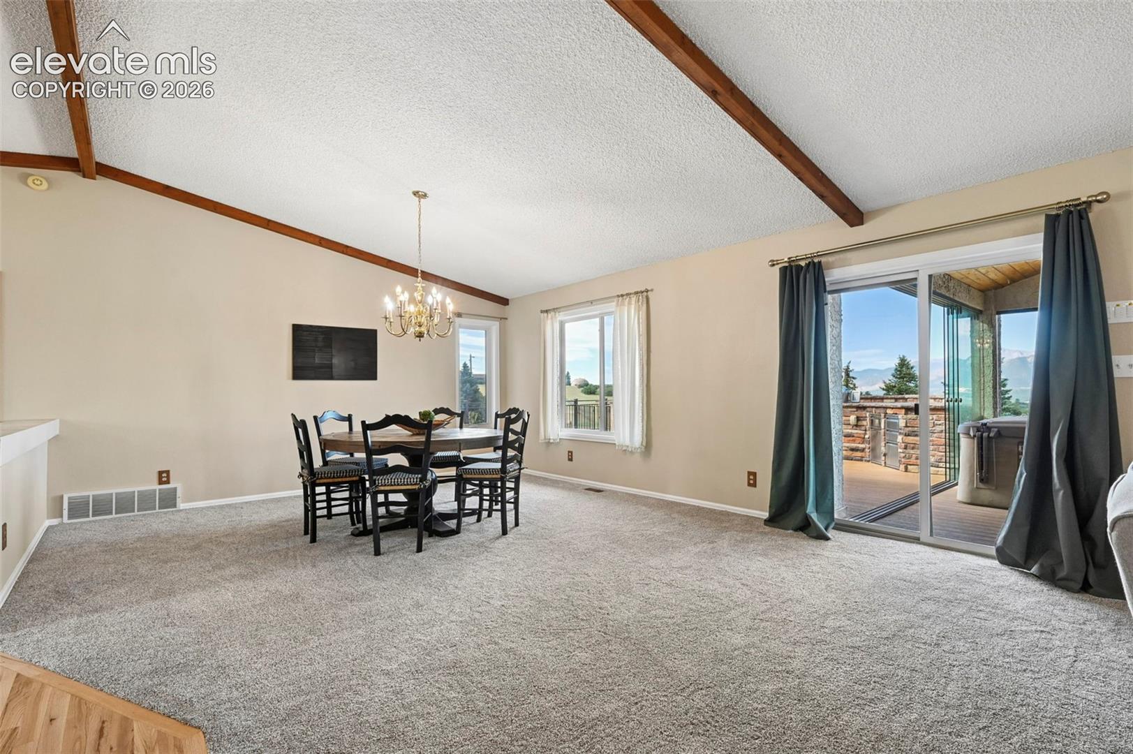 Vaulted ceiling with wood beam accents