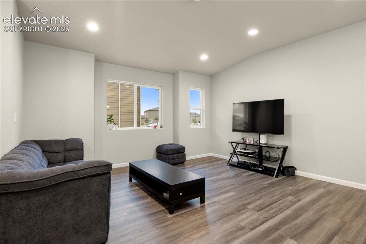 Recessed lighting, wood-finish flooring, and multiple windows
