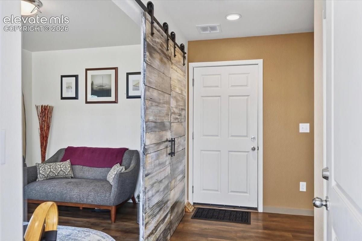 The foyer is spacious and opens to the garage and staircase.