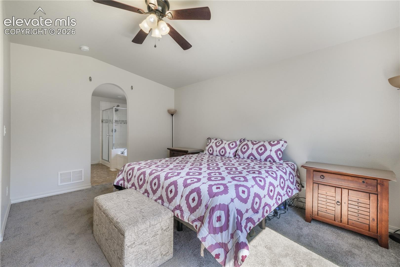 Main level primary bedroom with ensuite 5 piece bathroom with granite counters, large walk in closet and new carpet
