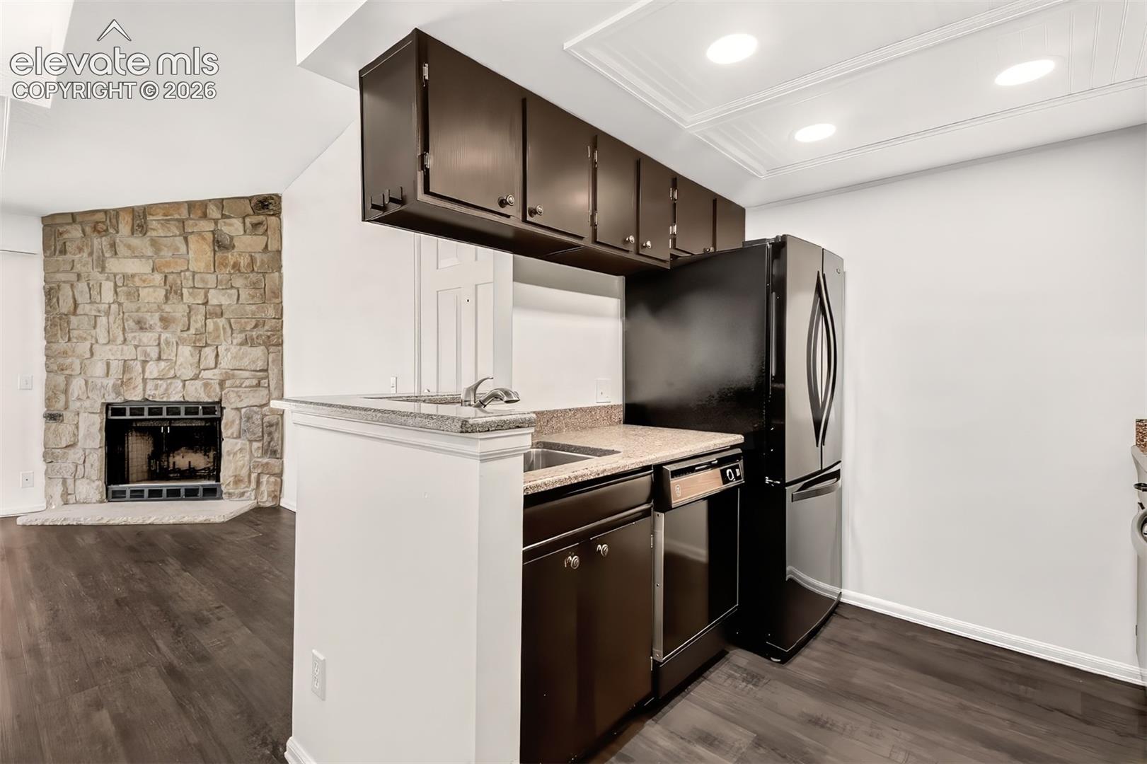 Kitchen featuring quartz countertops and built-in appliances.