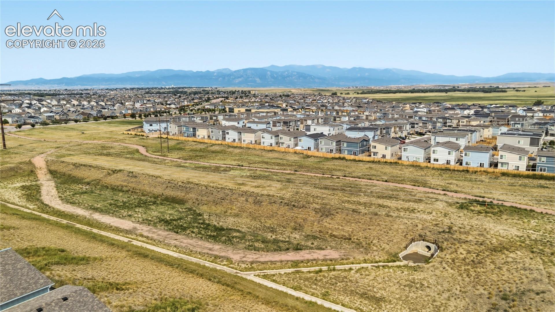 Open space with walking tails and mountain views.