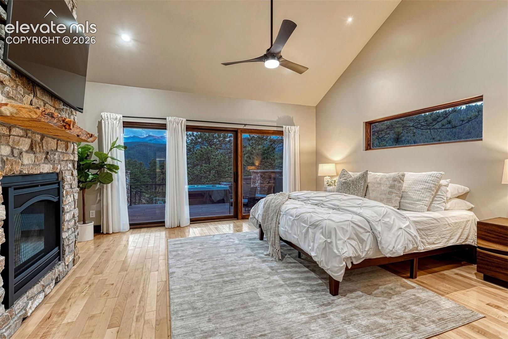 Luxurious Primary Retreat with Fireplace and opening to Deck with Hot Tub