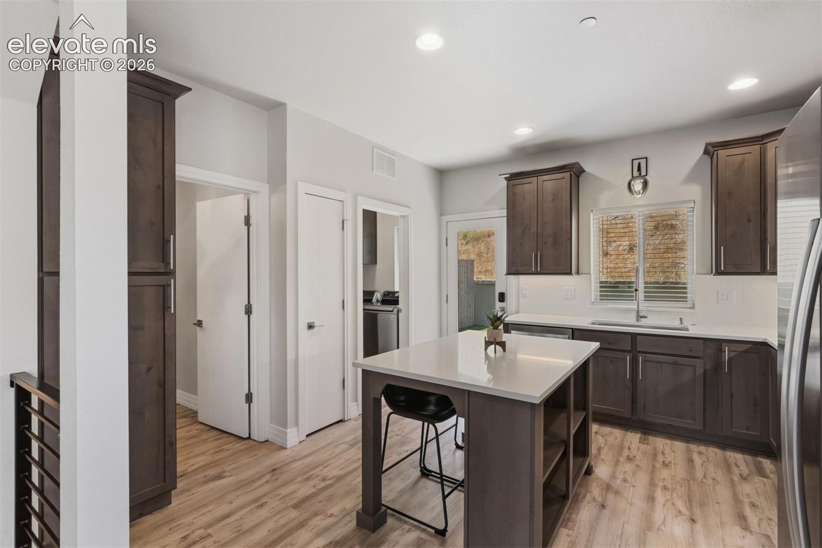 Kitchen with center island and walkout access to back yard