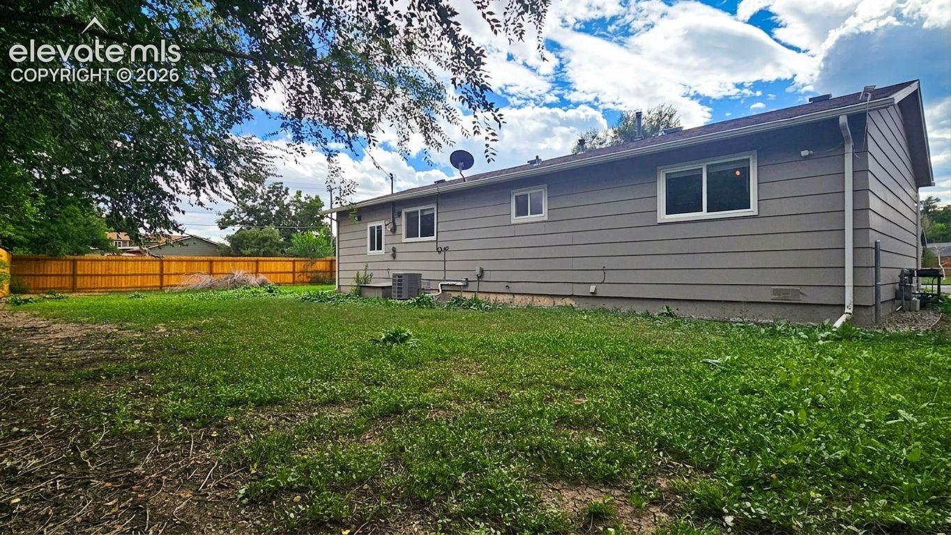 Expansive backyard featuring a wood privacy fence