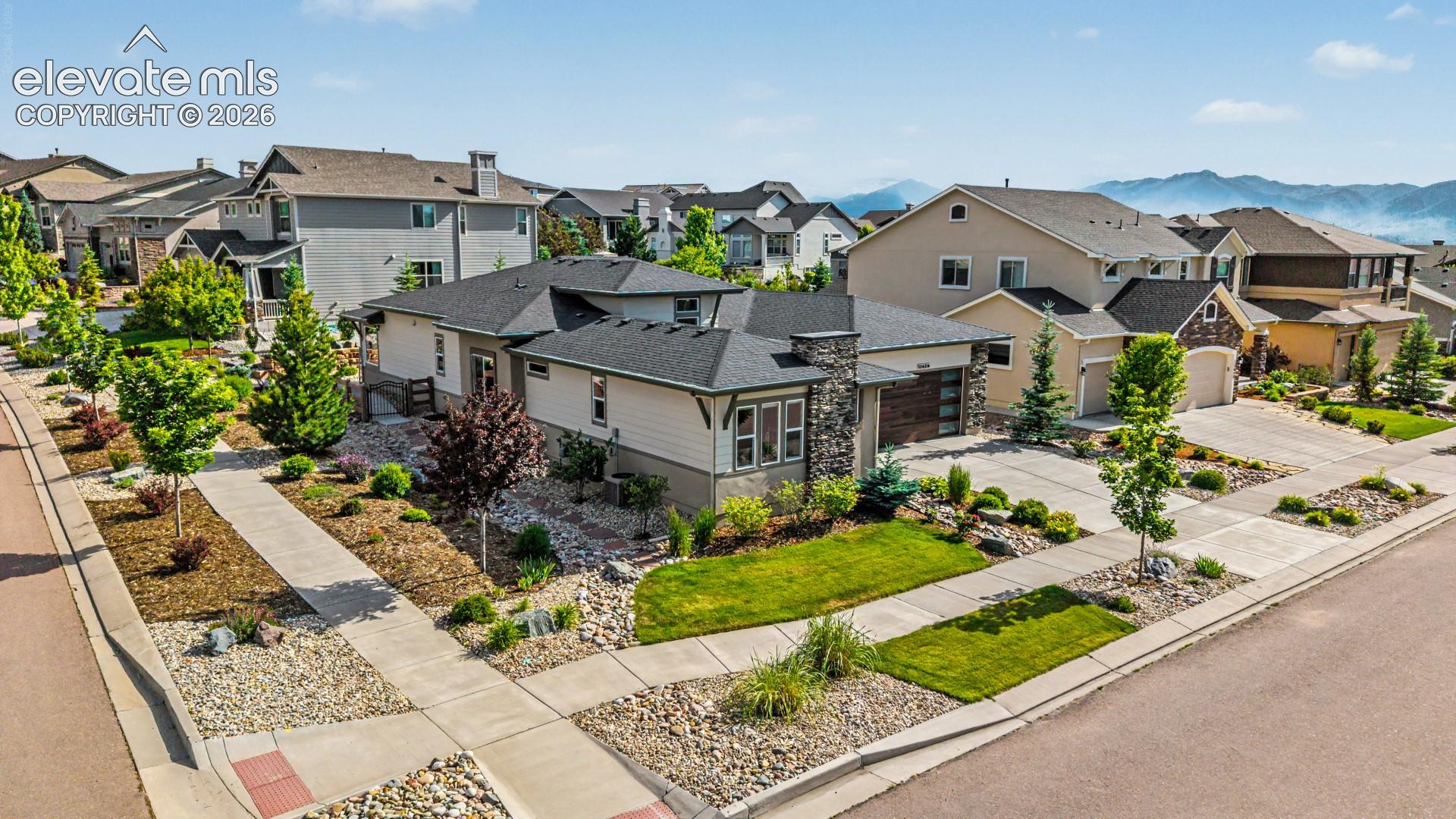 Single-story property featuring a stone and stucco exterior, an attached two-car garage, and a concrete driveway