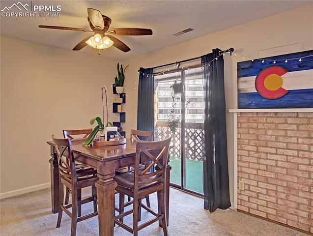 Ceiling fan in dining space. Fireplace was covered years ago.