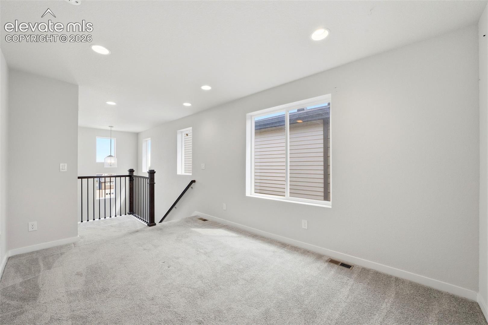 Recessed ceiling lighting, light gray wall paint, and white trim