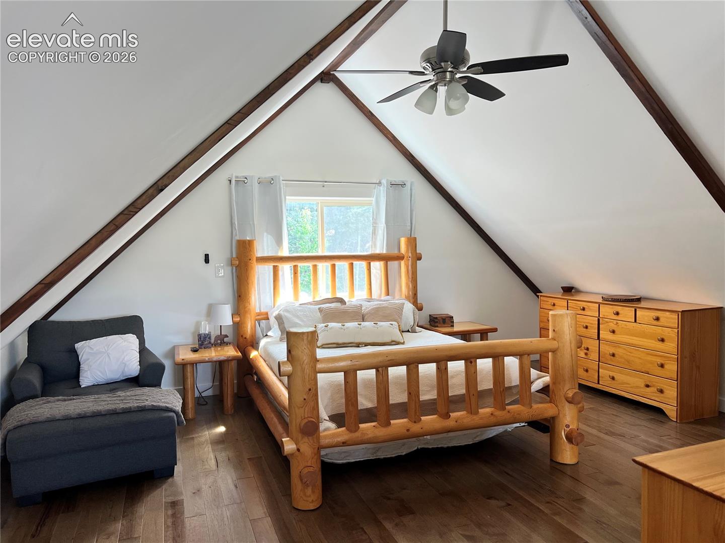 Angled white walls with exposed wood beams