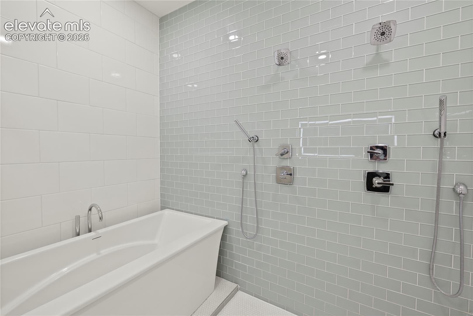 Spa shower with 6 heads and deep soaker tub inside the enclosure