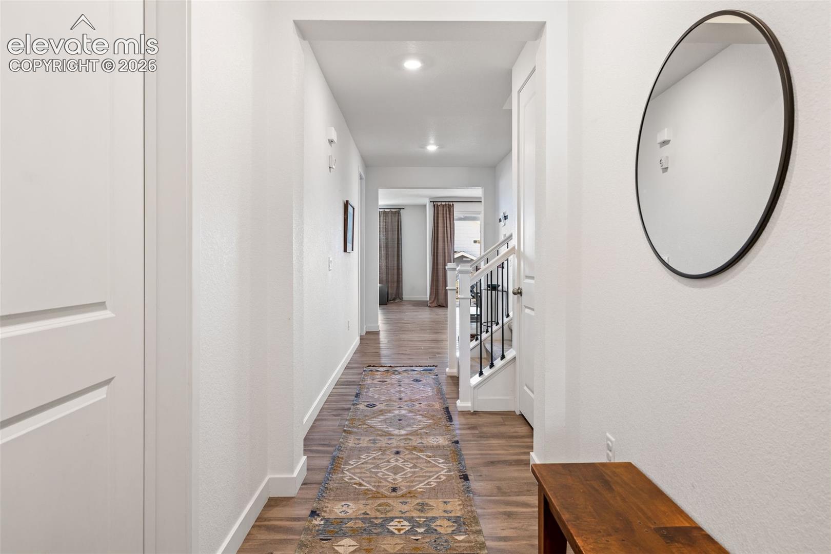 LVP flooring throughout, white painted walls, and recessed lighting
