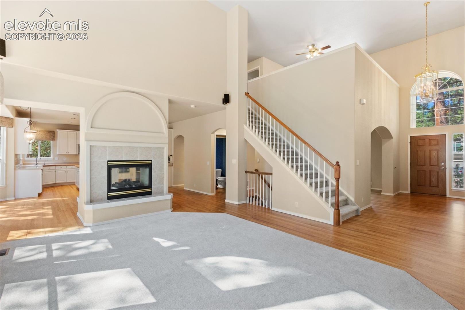 Family room with dual sided fireplace and wall of windows