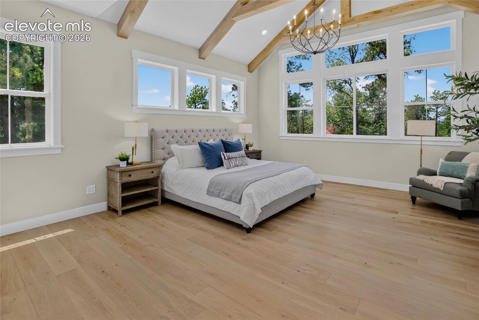 Primary suite w/ exposed beam vaulted ceiling