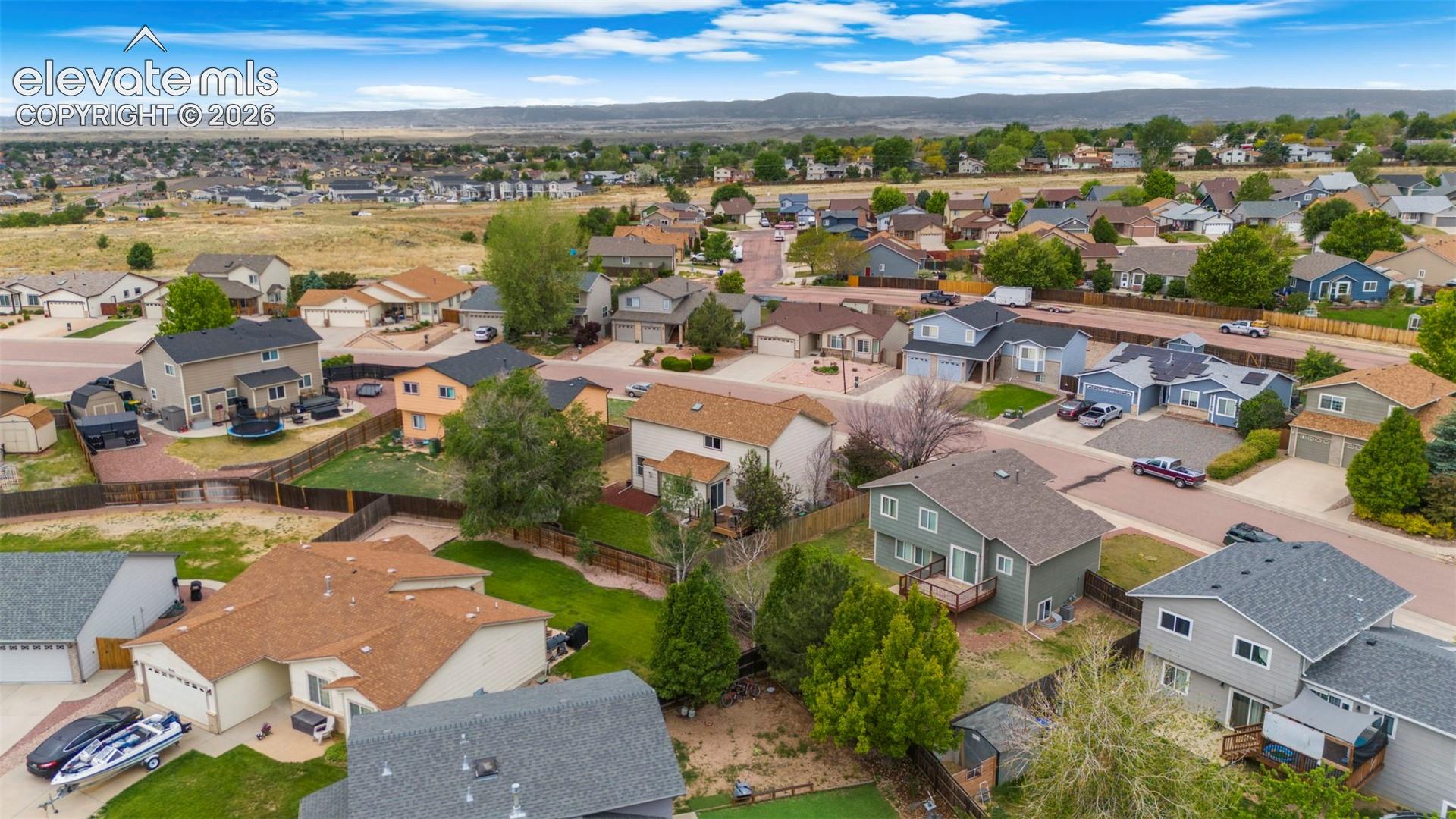 Residential neighborhood with established homes, paved streets, and varied landscaping