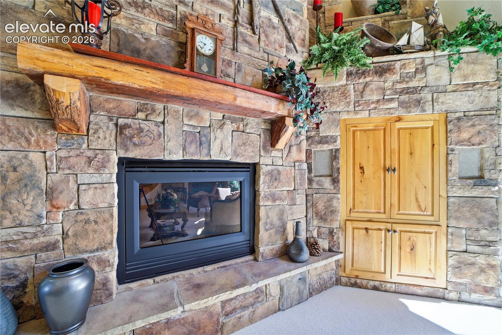 Impressive stone fireplace, rustic mantle, built in entertainment center