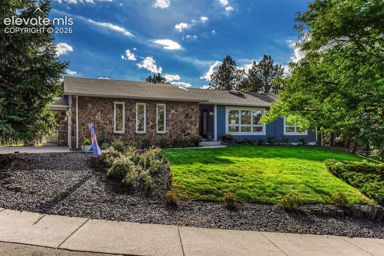 Designed for both everyday living and the moments that make a home memorable, this ranch with finished basement has been thoughtfully transformed through an extensive four-year renovation, bringing together warm character, sophisticated updates and spaces made to enjoy in every season. Wood beams grace cathedral ceilings, beautiful wood flooring, updated lighting and fresh paint set the tone throughout the main level. The remodeled kitchen features quartz surfaces, distinctive Thomasville cabinetry and an impressive appliance collection including a 48” Kucht  8 burner range and hood, Miele built-in plumbed barista coffee system, Blomberg dishwasher and Bespoke glass-front refrigerator. Two generous kitchen islands provide plenty of room for cooking, conversation and morning coffee. The expanded primary suite offers a walk-in closet and beautifully remodeled bath with soaking tub, oversized shower, dual vessel sinks and separate water closet all surrounded by dramatic marble walls and floors. An additional bedroom on the main level provides flexibility for guests, office or hobbies. Downstairs, two generously sized bedrooms join a spacious rec room, wet bar and full bathroom with a dry/wet sauna, creating a lower level with plenty of room to spread out. Outdoor living extends across multiple seating areas, a gorgeous deck and outdoor kitchen with a covered pergola. An enclosed sunroom makes the hot tub a year-round retreat, even when the snow begins to fall. Hike and bike to your delight as this home has direct access to the North Woods trail leading to Austin Bluffs Open Space and Pulpit Rock! Centrally located with convenient access to Academy Boulevard, Woodmen Road and I-25, shopping and major routes are nearby, with the United States Air Force Academy approximately 10 minutes away.