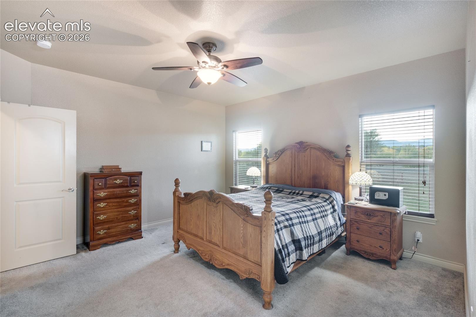 Primary bedroom with large windows with Front Range and Pikes Peak views