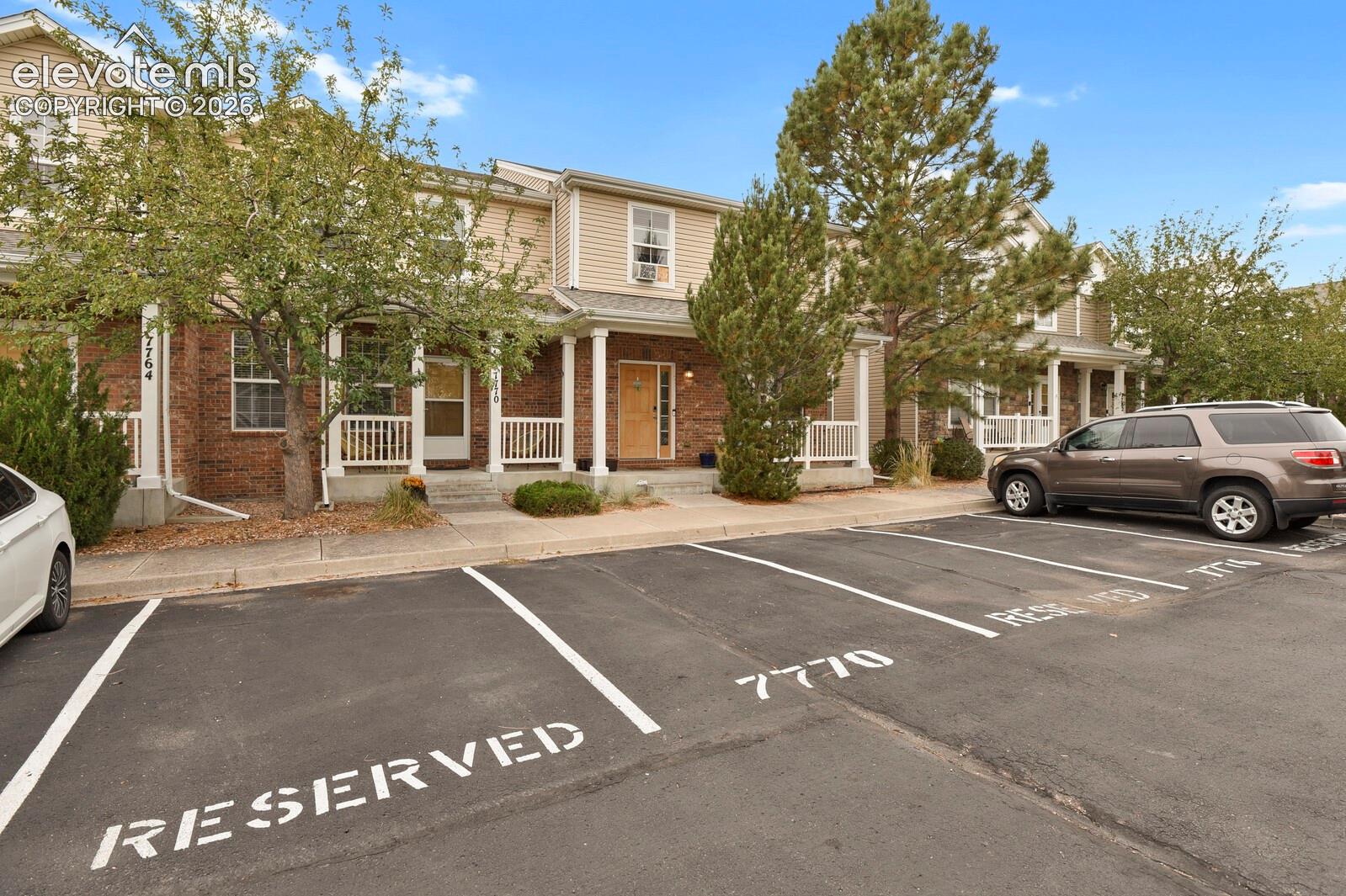 Front of the home with designated parking and porch