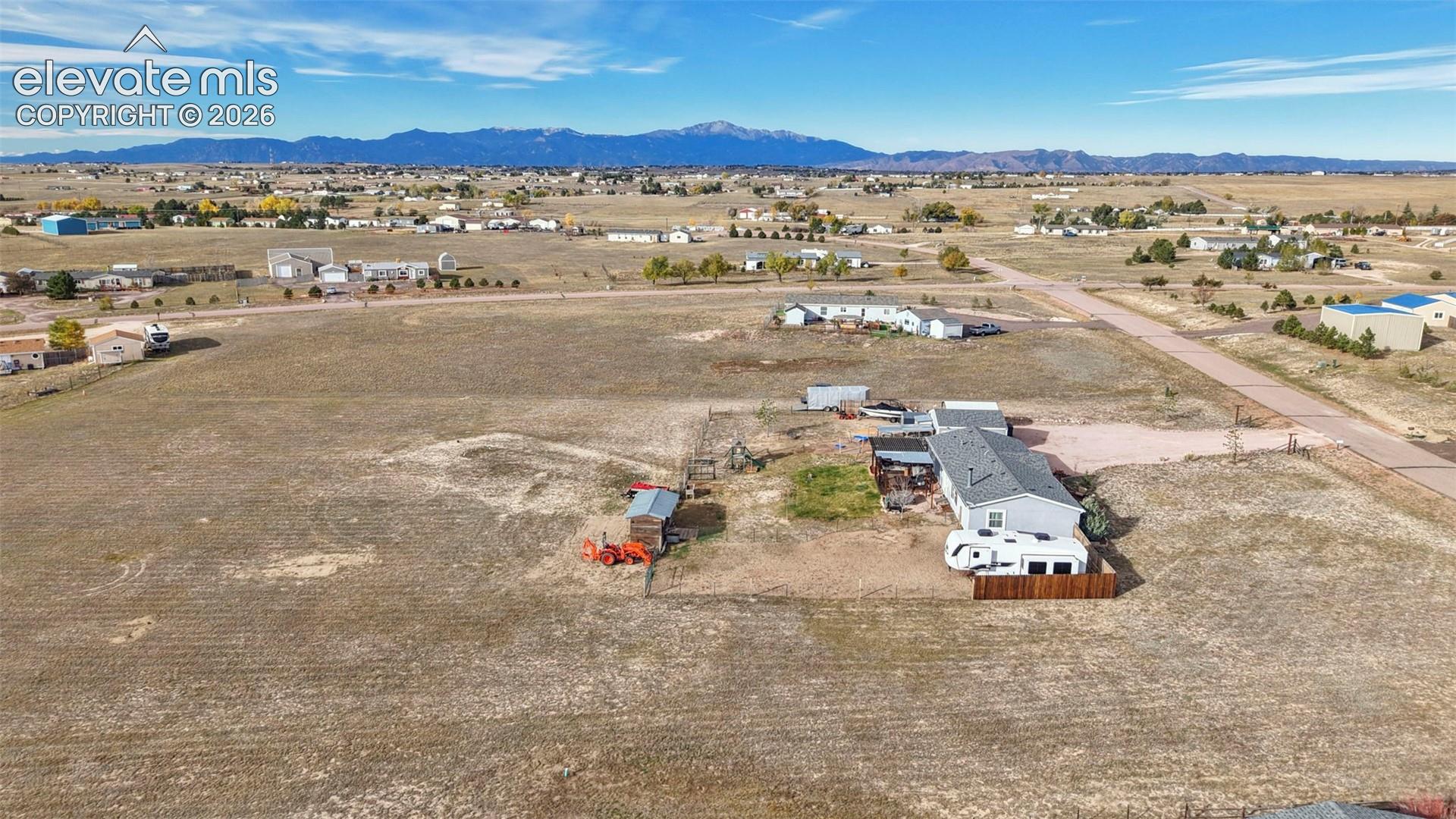 Expansive acreage featuring a mountain backdrop and a detached storage structure