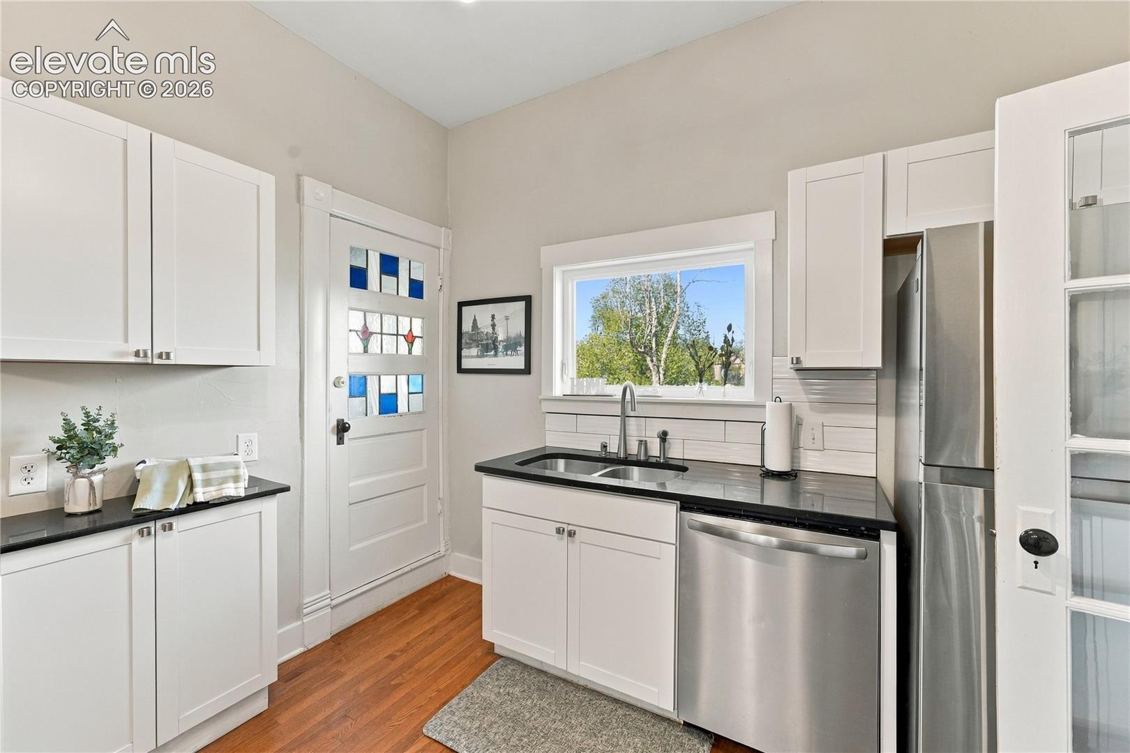 Primary kitchen on main, with updated appliances, solid surface counters and bar seating