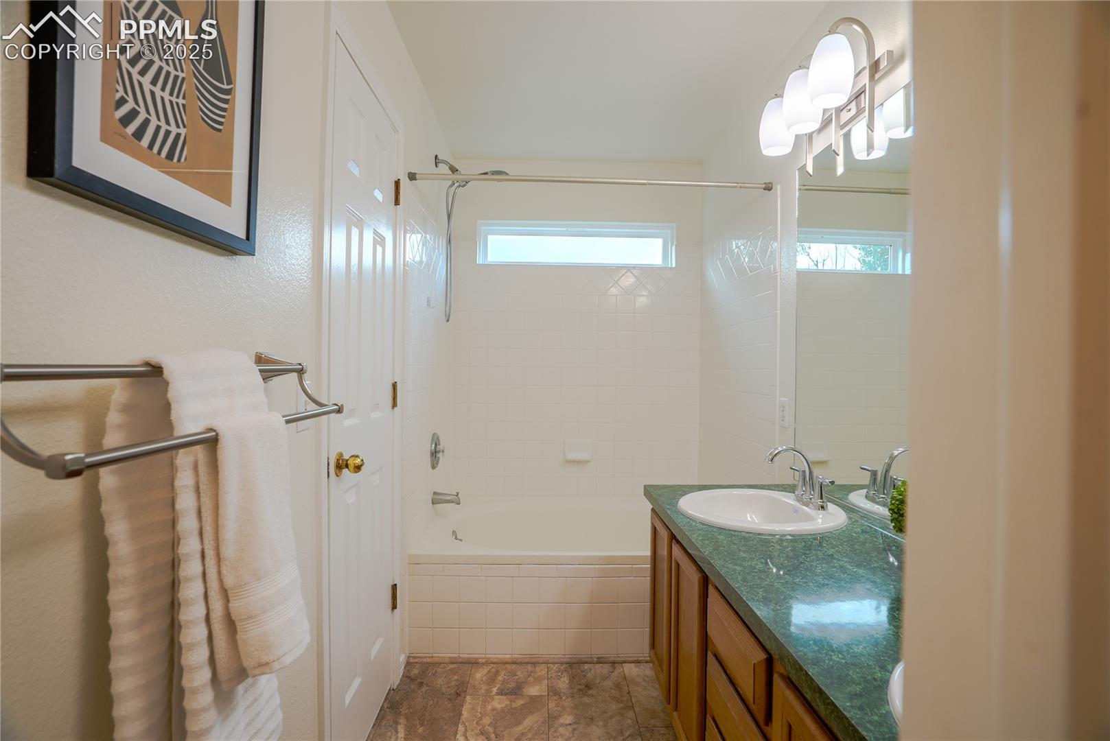 Full bathroom featuring shower / bath combo and vanity