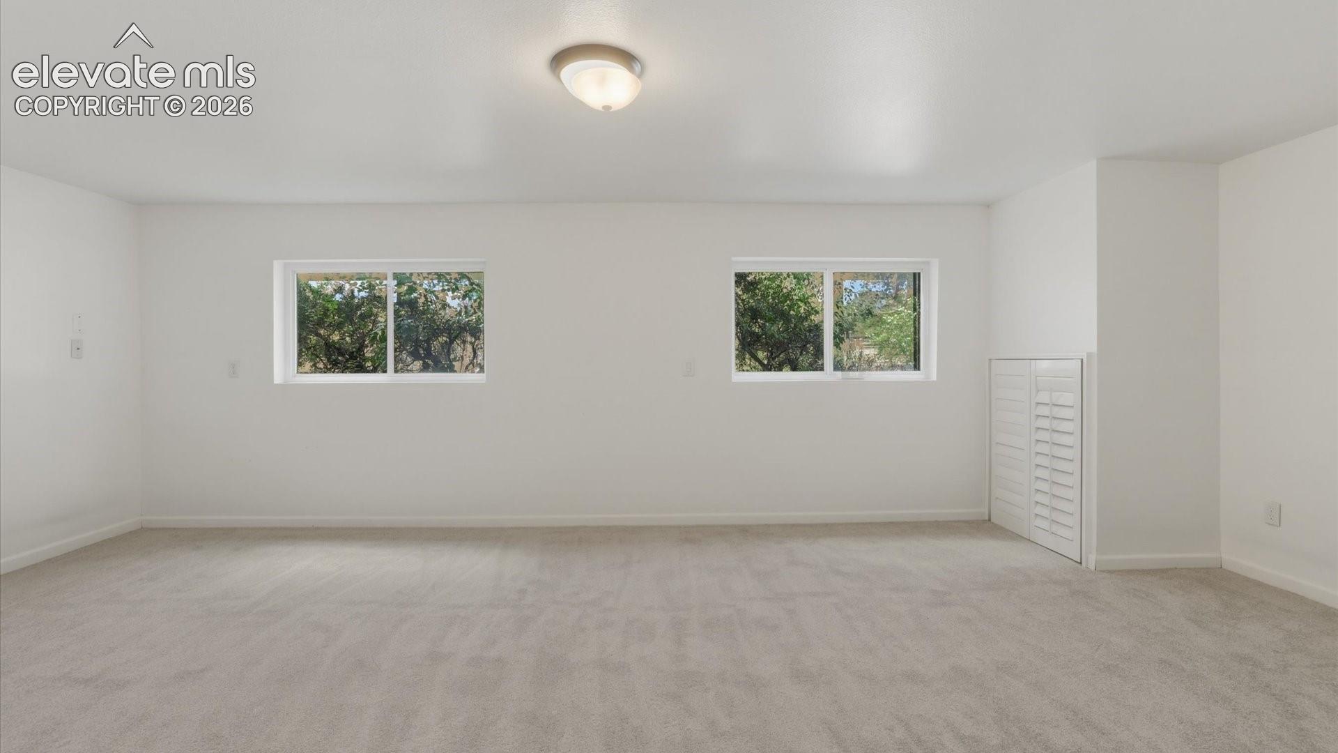 Versatile Lower Level Family Room ideal for a media room, playroom, gym, or office.
