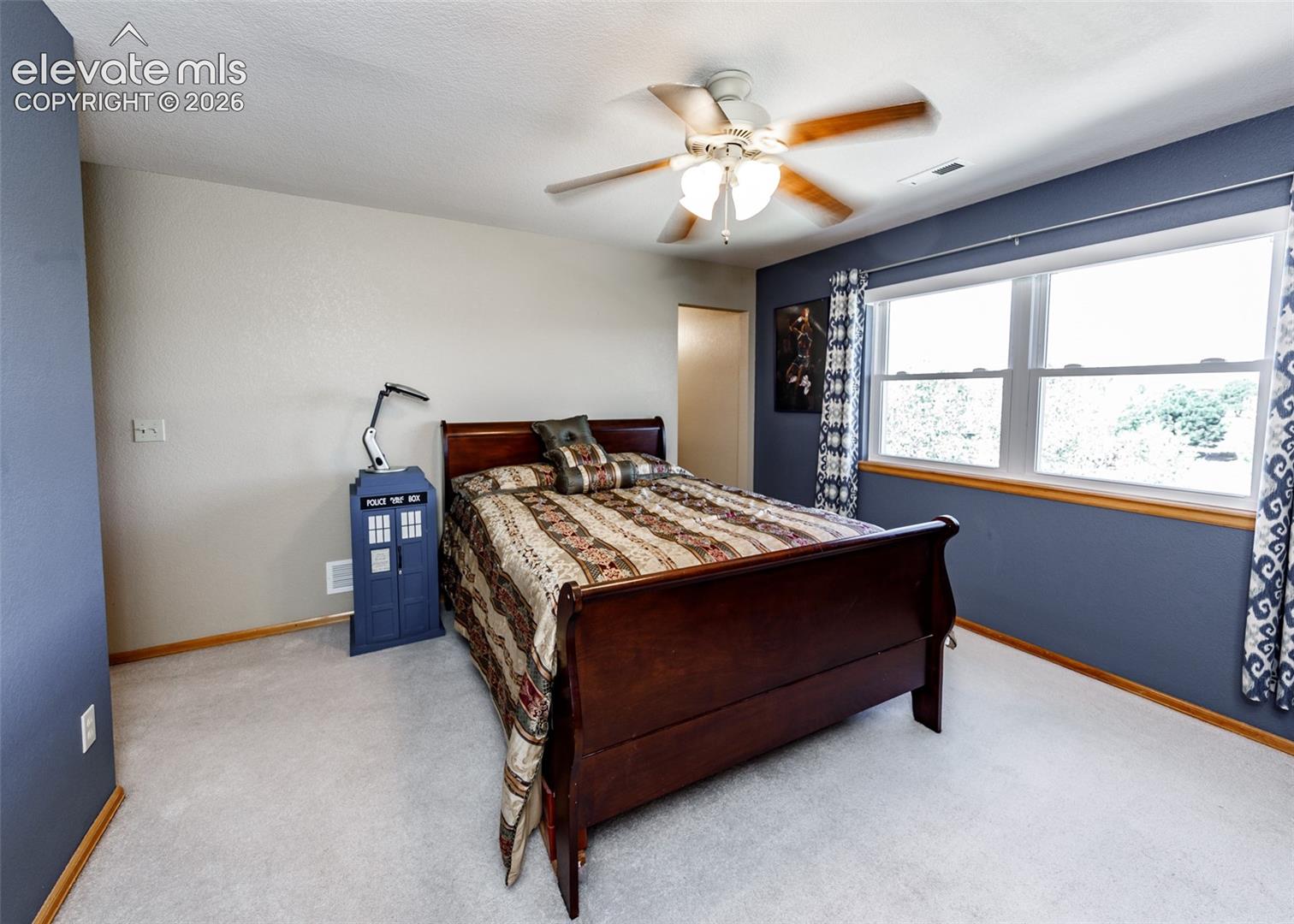 Recessed lighting, ceiling fan with light fixture, dual pane windows, and light neutral carpeting