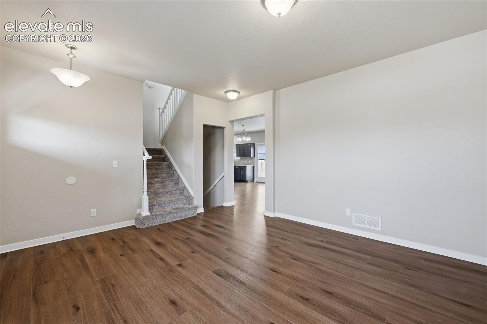 The bright entry opens to the staircase and offers a clear sightline into the heart of the home.