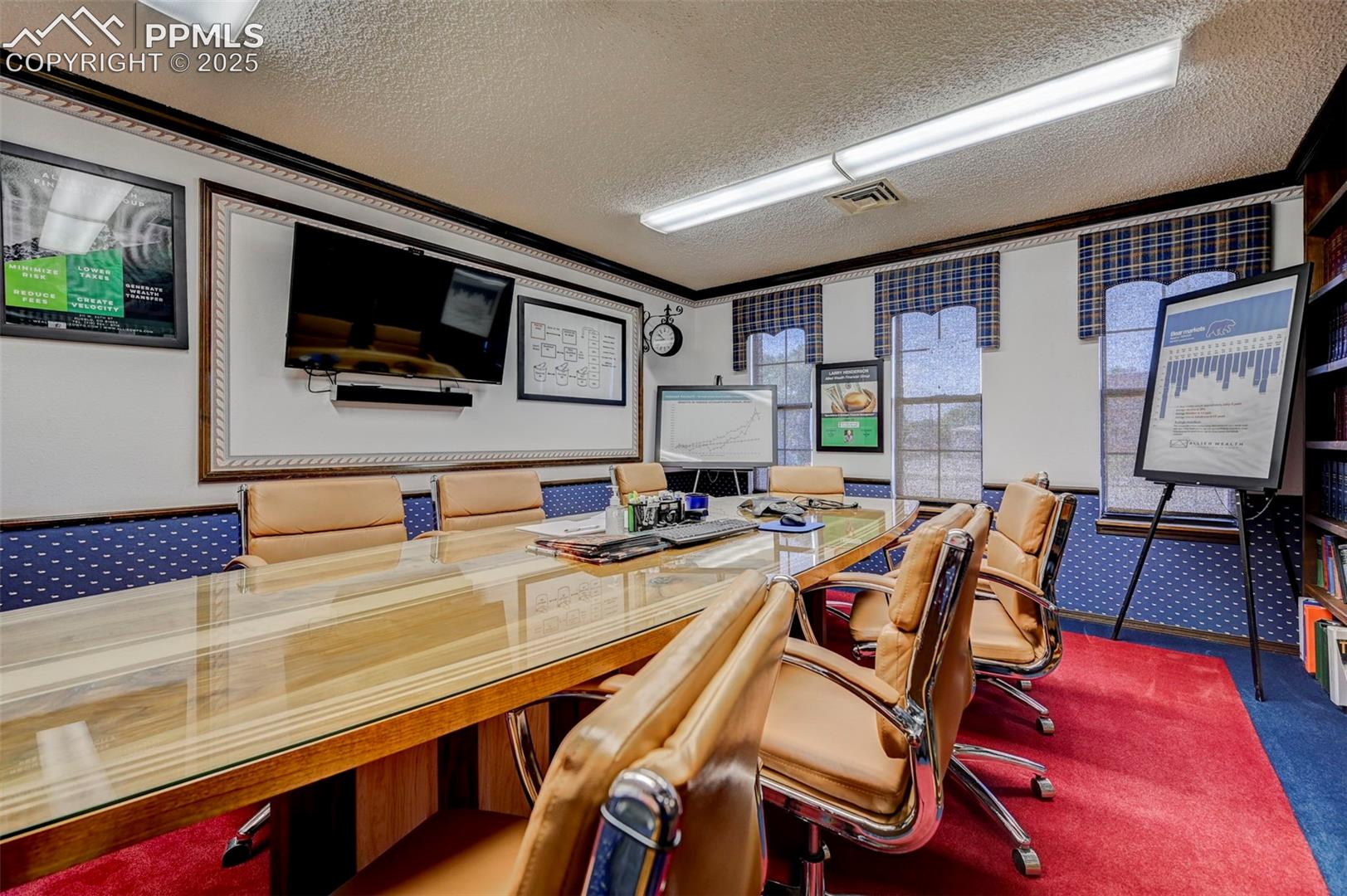 Office with crown molding, a textured ceiling, and carpet flooring