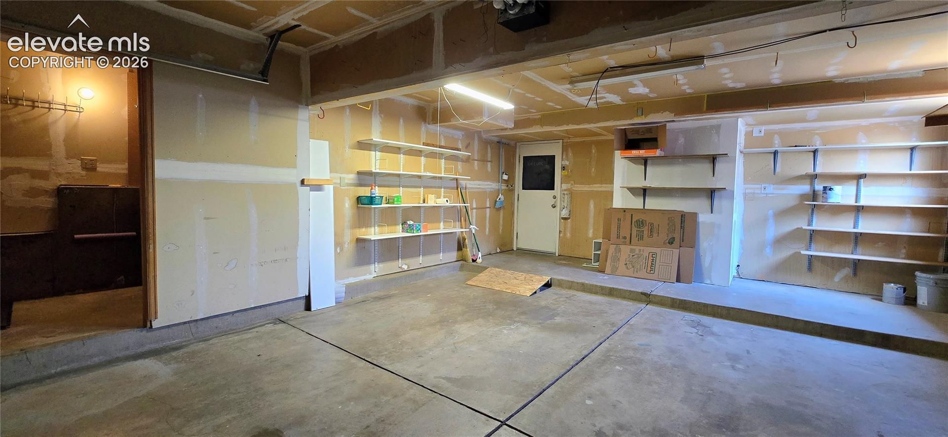 Garage with storage shelves, and laundry nook (insulated)