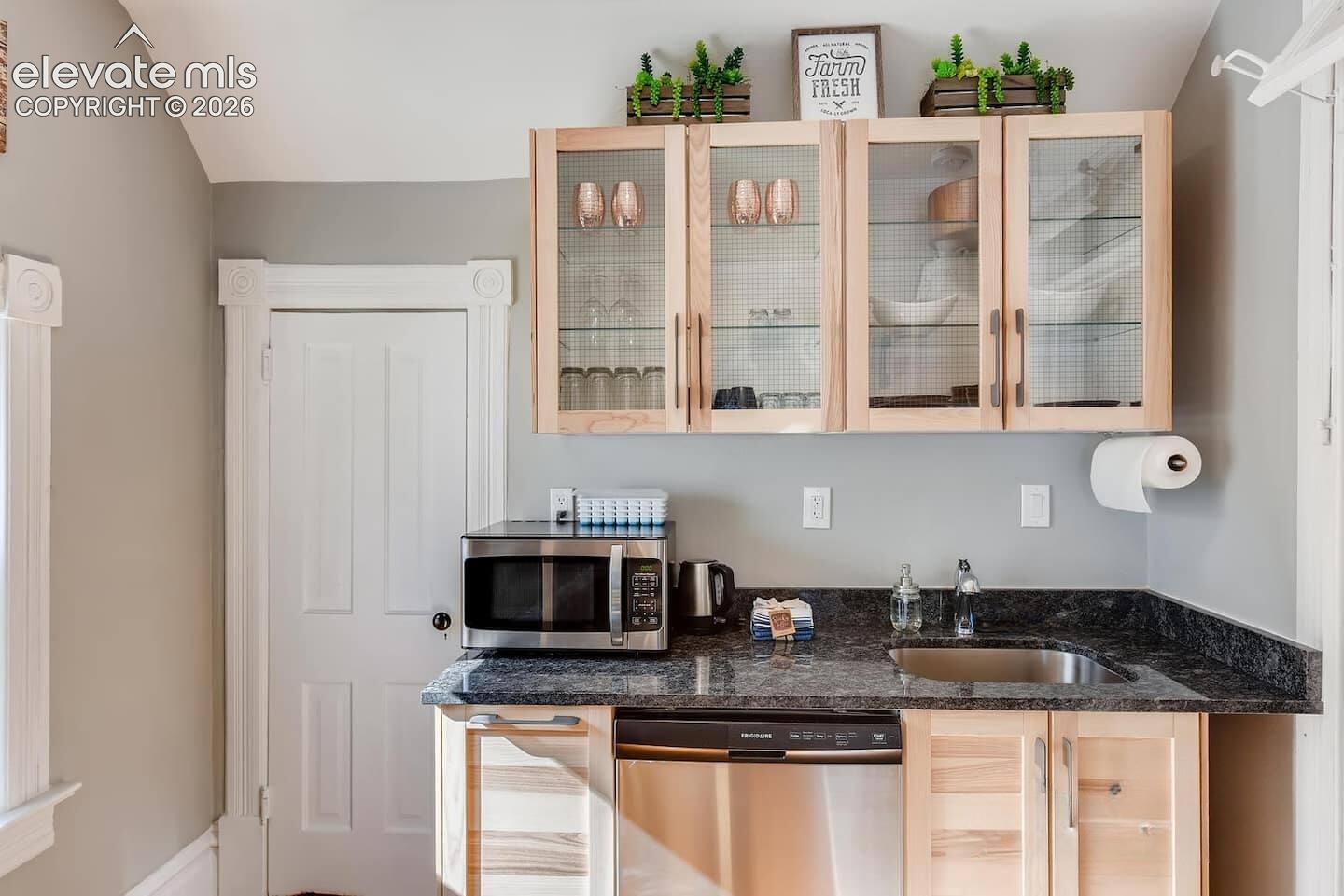 Second floor full kitchen with dishwasher, range and refrigerator with small pantry and dining space.