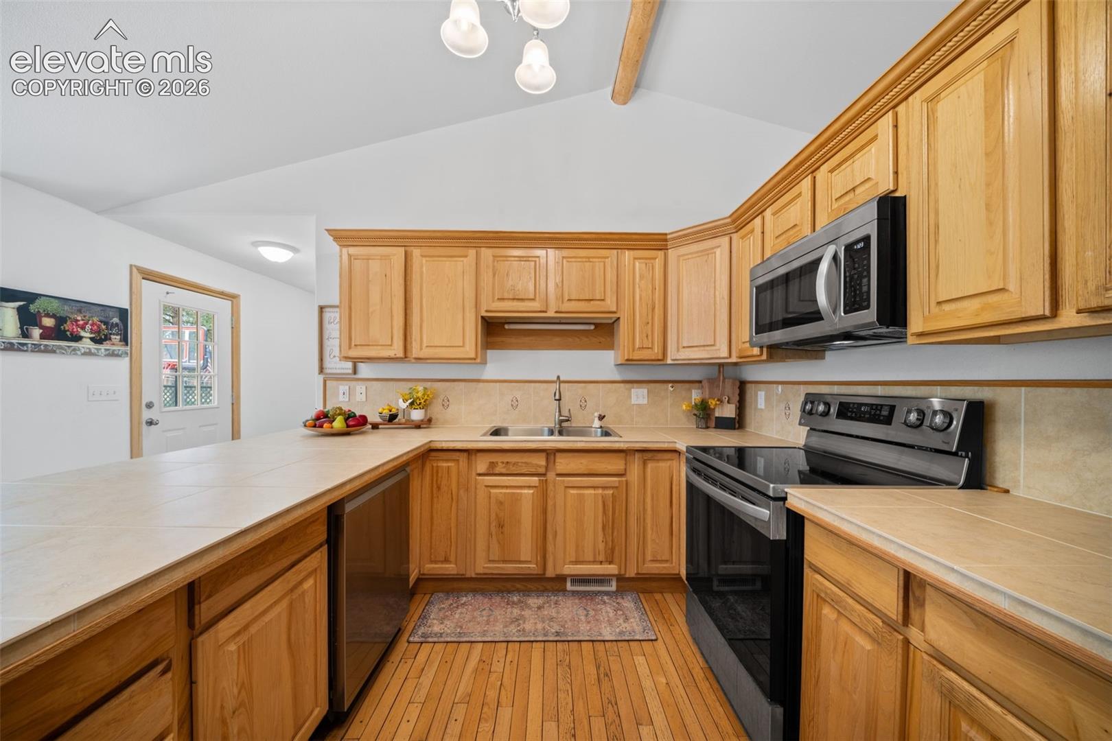 Main level kitchen offers spacious countertops and stainless steel appliances