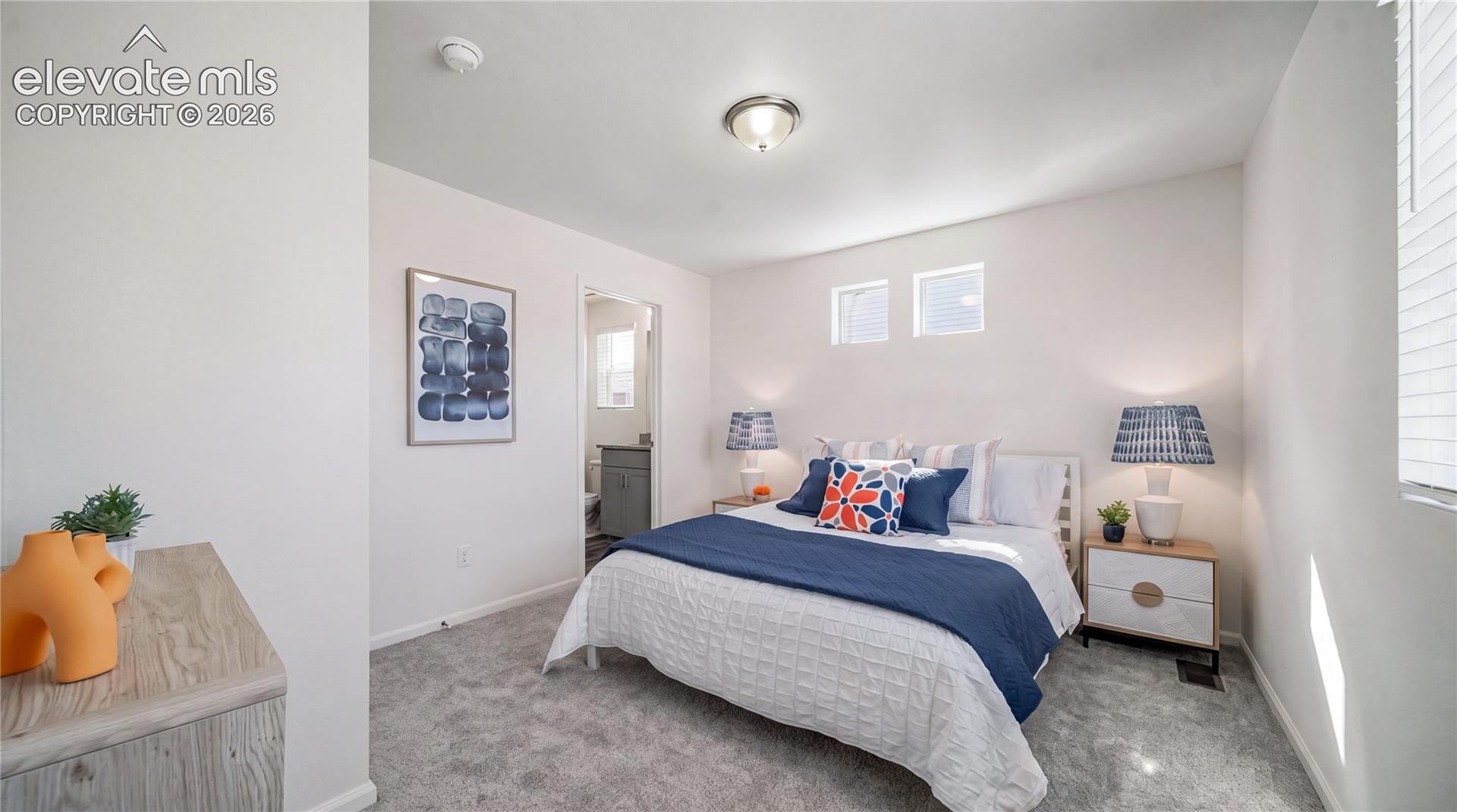 Neutral-toned carpeting, high-placed windows, and a central ceiling light fixture
*photos of a model home*