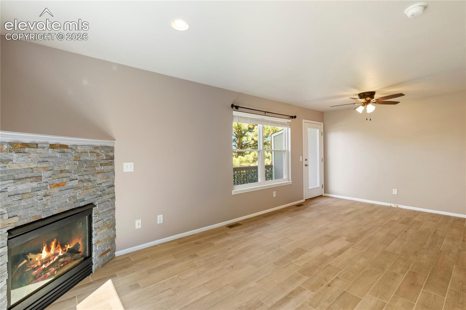 New floors and stacked stone on fireplace. Walks out to back deck.