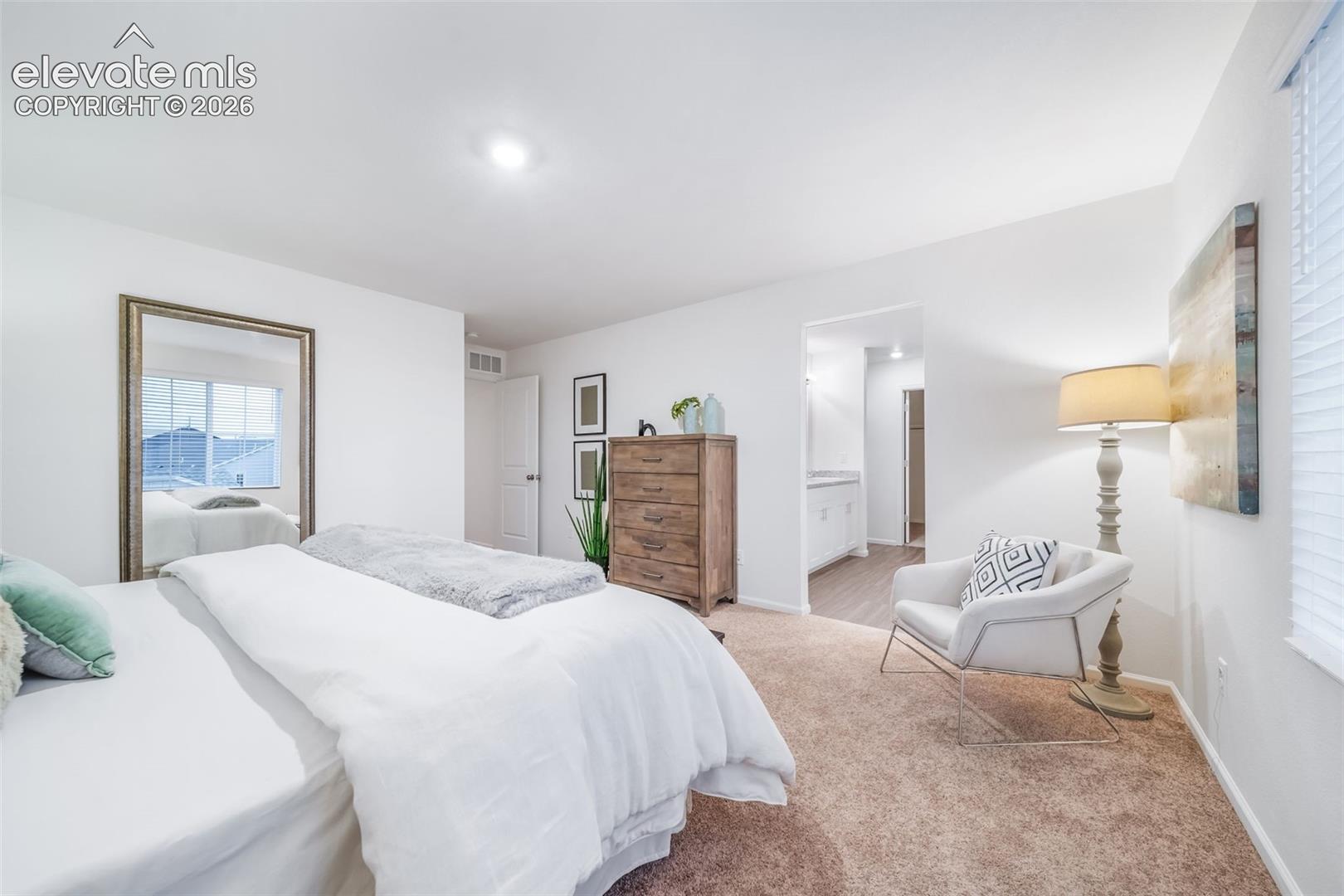 Recessed lighting illuminates the room, complemented by a window with blinds
*photos of a model home*