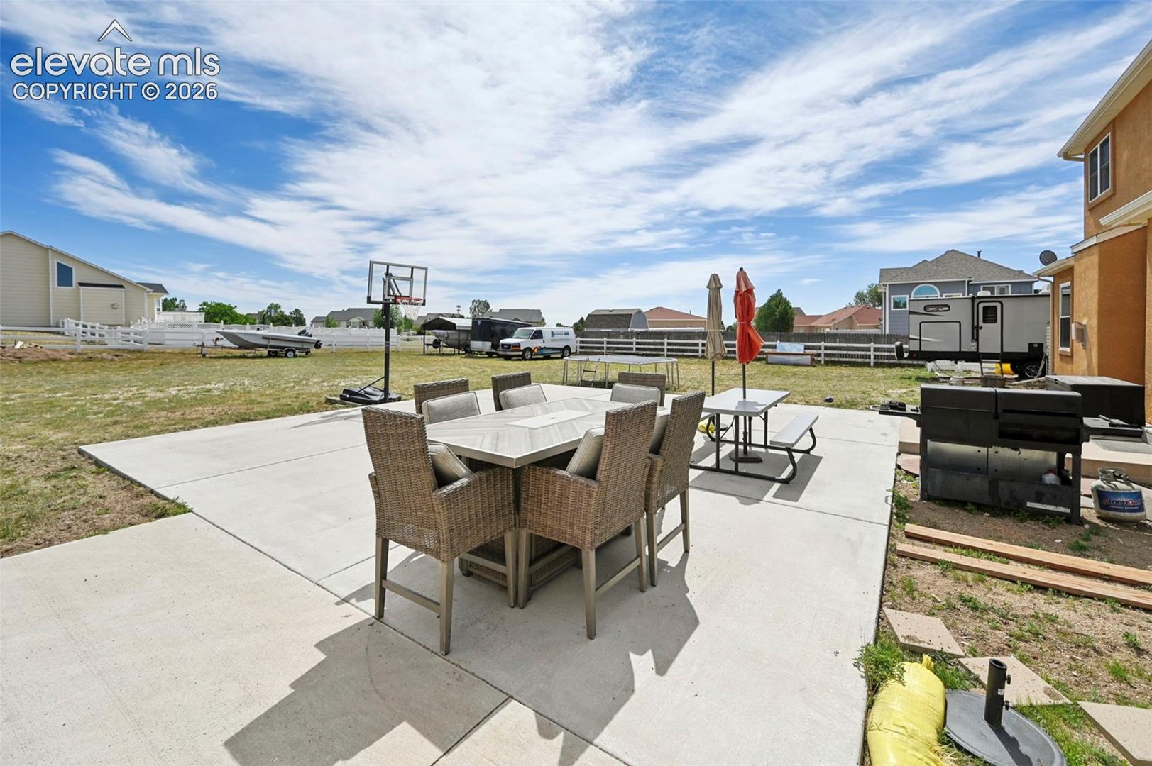 Expansive concrete patio offering a broad outdoor living area