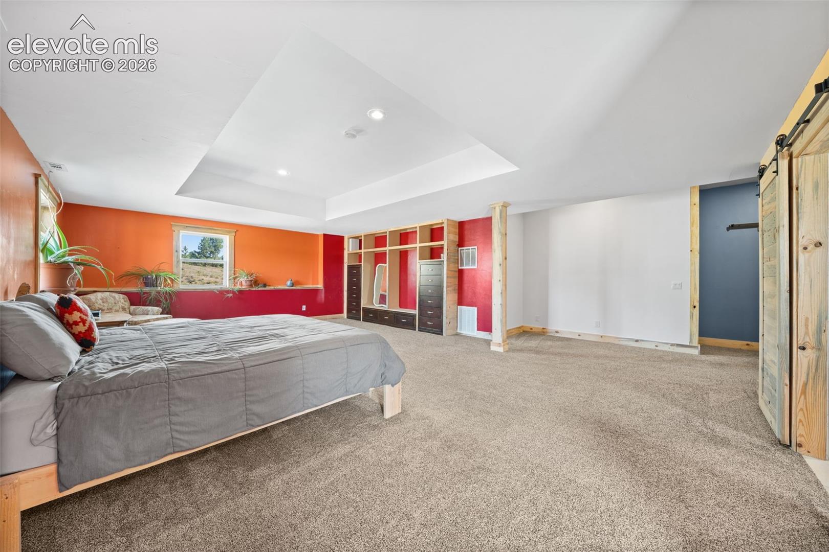 Expansive walkout primary bedroom with abundant space.
