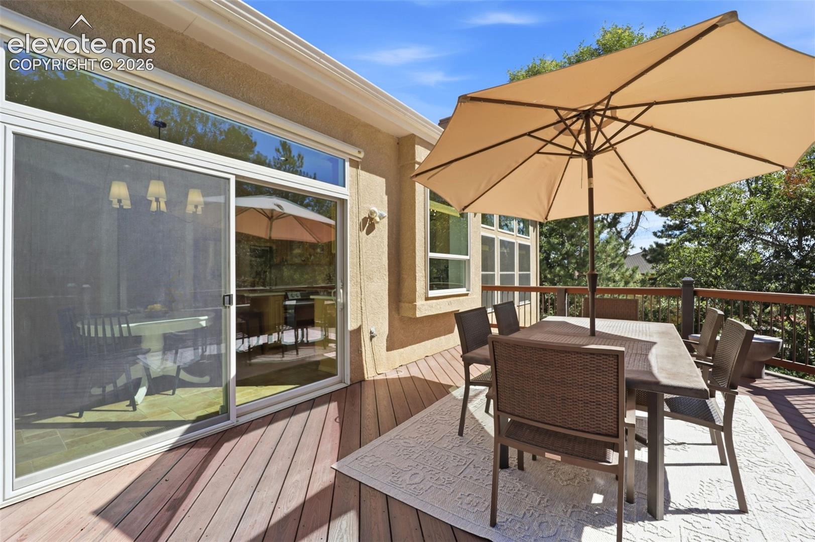 Expansive outdoor trex deck overlooking a mature and treed backyard