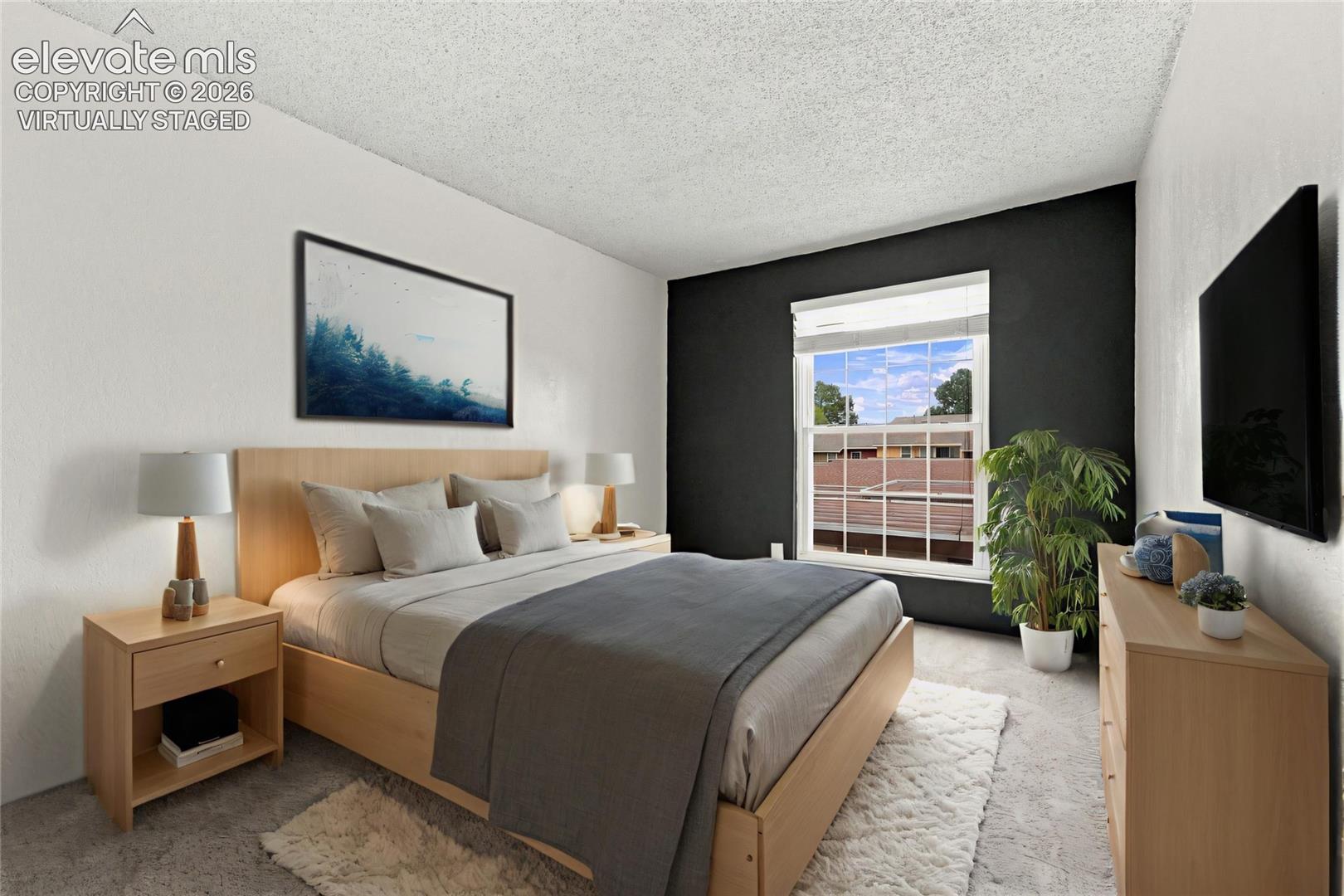 Room featuring a contrasting dark accent wall, neutral carpeting, and a dual-pane window
Virtually Staged