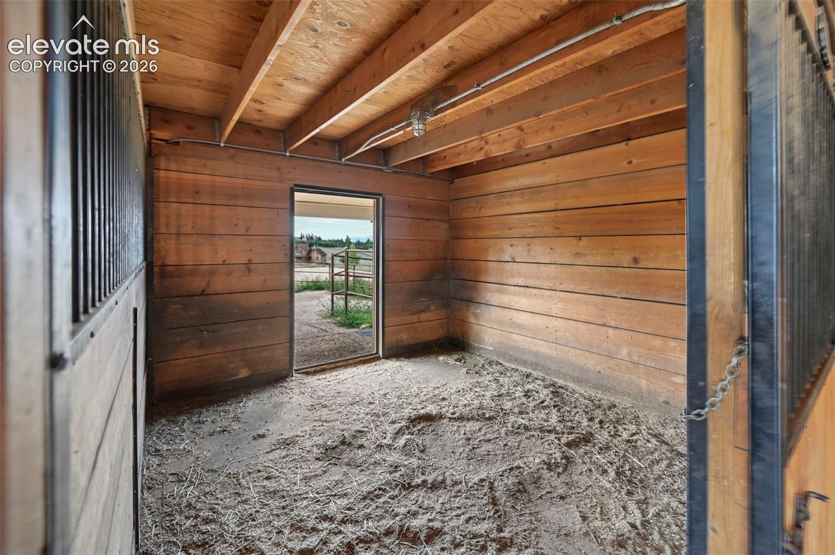 Interior stall with wood plank walls and corall access