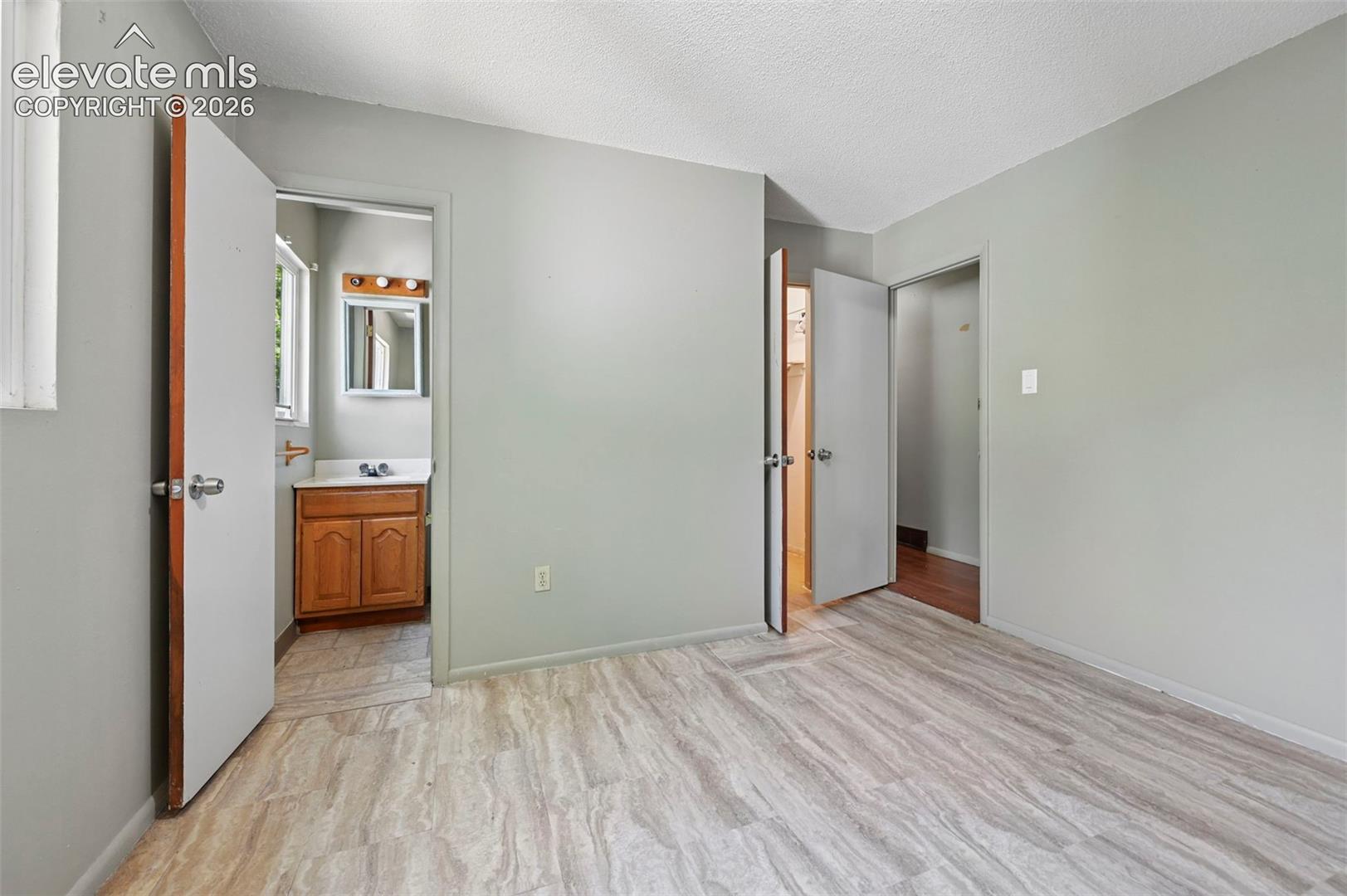 Light gray walls and wood-finish flooring define this interior space
