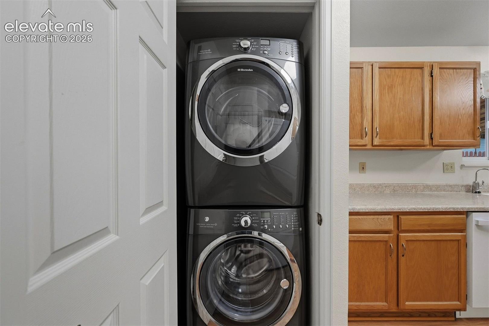 Laundry 1 is a stackable laundry with washer and dryer in kitchen