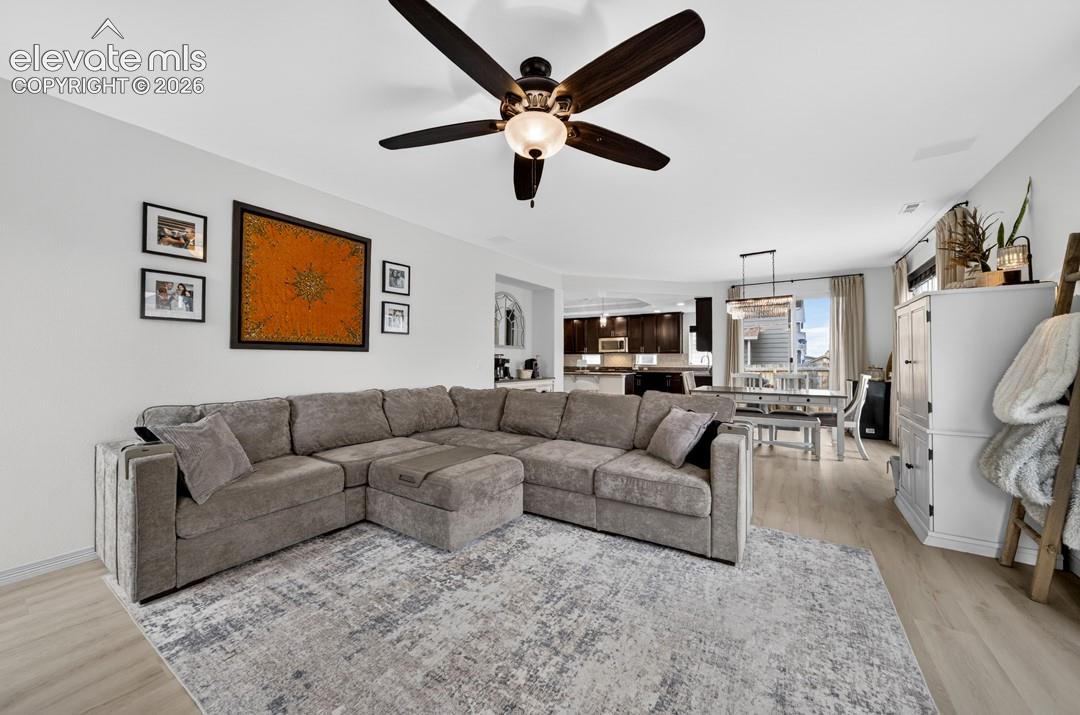 Gas fireplace, large windows, ceiling fan, luxury vinyl, surround sound speakers