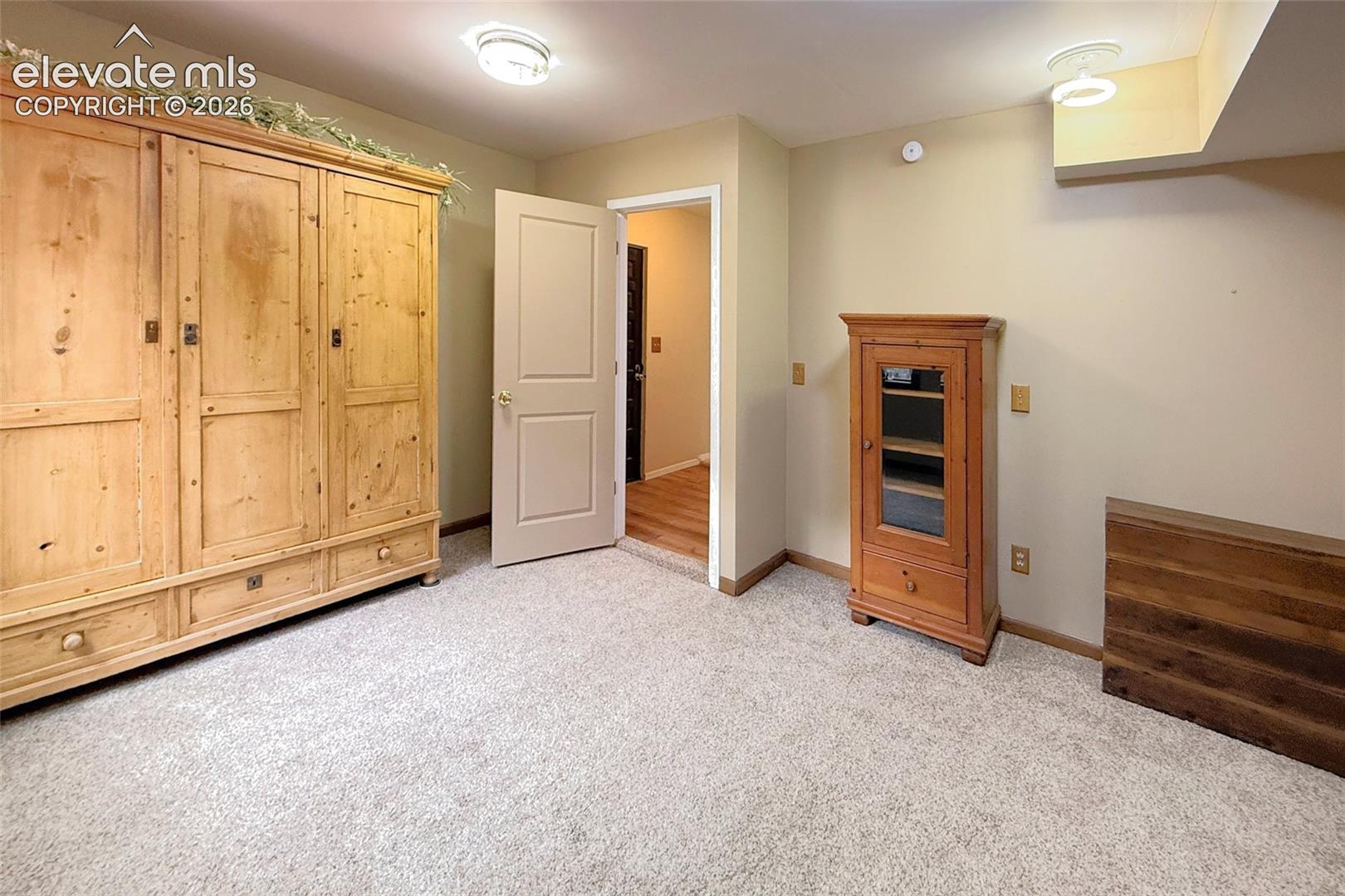 Interior room featuring neutral wall paint, wall-to-wall carpeting, and recessed ceiling lighting